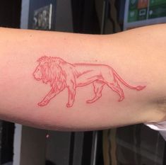 a red ink drawing of a lion on the arm