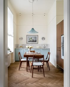 the dining room table is set with four chairs