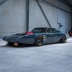 a car parked in a garage next to a wall