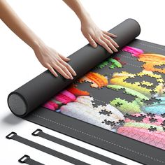 someone is placing the puzzle on top of the mat to make it look like they are going