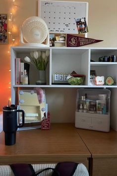 a wooden desk topped with shelves filled with personal items