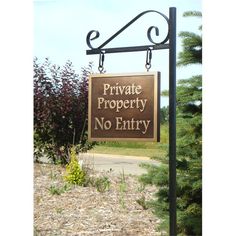 a private property sign in front of some bushes