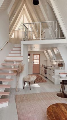 a living room filled with furniture and a staircase