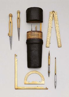 an assortment of sewing tools including scissors, tape measure and other items on a white surface