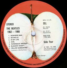 an apple label with the beatles's logo in red and white, on a black background