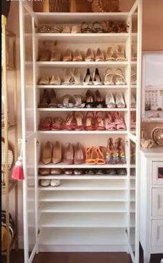 a closet filled with lots of different types of shoes and purses on top of shelves