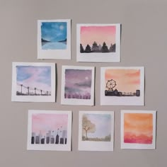 six watercolor paintings are arranged on a wall in front of a gray background, with trees and ferris wheel at the far end