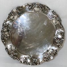 a silver plate with ornate designs on it