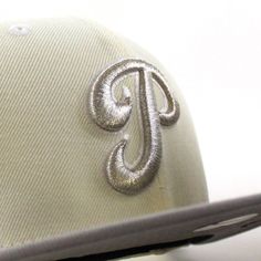 a baseball cap with the letter j on it's front and side panels in silver sequins