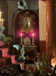 an elaborately decorated room with candles and statues