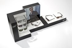 three pairs of sunglasses are on display in a black and white box with an image of a man's face