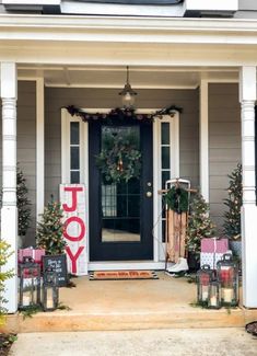 a front porch decorated with christmas decorations and presents