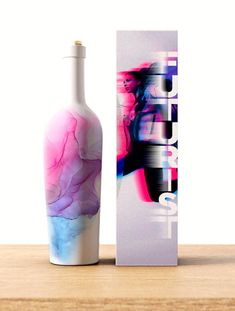 an empty bottle sitting next to a box on a wooden table with the packaging in front of it