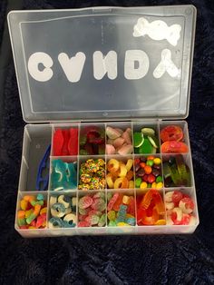 a plastic box filled with lots of different colored candies in it's compartments