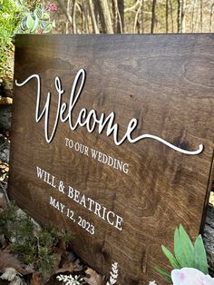 a wooden sign that says welcome to our wedding