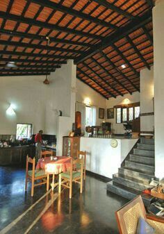 the inside of a building with tables and chairs