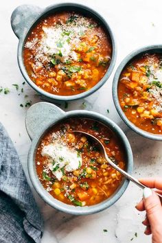 three bowls filled with soup and topped with parmesan cheese