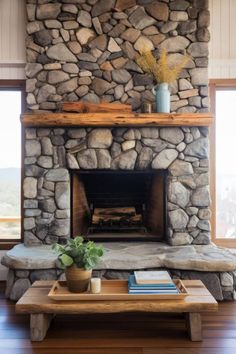 a living room with a stone fireplace and wooden coffee table in front of the fire place