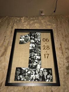 the number one made out of photos is displayed in a frame on top of a bed