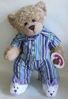 a brown teddy bear wearing pajamas and bunny ears