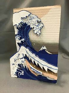 an artistic paper sculpture depicting the great wave