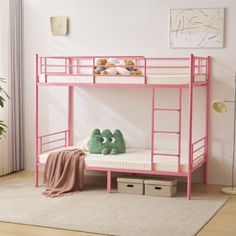 a pink bunk bed sitting in a bedroom next to a green stuffed animal on top of it