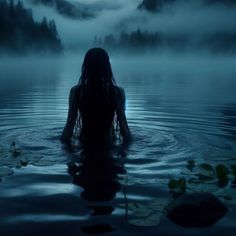 a woman is floating in the water with her back turned