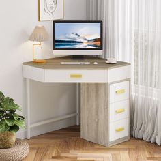 a computer monitor sitting on top of a desk next to a potted green plant