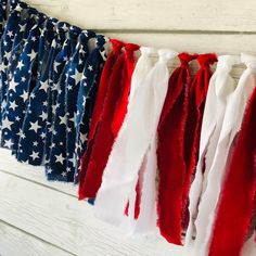 red, white and blue american flags hanging on a wall