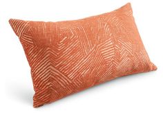 an orange and white pillow on a white background