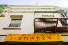 a yellow sign that says golden ate fortune cooke factory on the side of a building