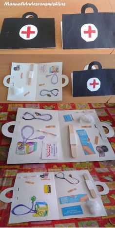 two medical kits sitting on top of a table next to each other with scissors and tape