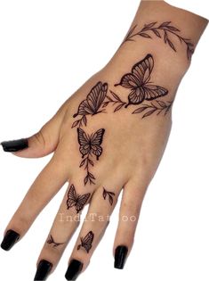 a woman's hand with tattoos on it and butterflies flying around the wrist area