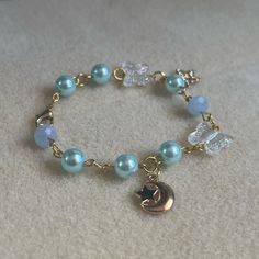 - One Of A Kind Beaded Charm Bracelet - Featuring Light Blue Pearl Beads, Clear White Butterfly Beads, A Gold Metal Crescent Moon Charm, A Star Charm That Says “Just For You,” And Gold Metal Links - Gold Colored Hardware - Clasps Closed. No Stretch. - Size/ Circumference Is 6.5” (See Picture) - Handmade (By Myself). Perfect To Treat Yourself Or To Give As A Gift! **Add 2 Jewelry Items Marked “2 For $20” To Your Bundle And I Will Send You An Offer For $20** Check Out The “Boutique” Tab In My Clos Blue And Gold Bracelets, Blue Bracelets With Star Charm And Round Beads, Blue Jewelry With Moon Charm And Round Beads, Cute Homemade Bracelets, Cute Blue Bracelets For Party, Diy Charm Bracelet Ideas, Star Cartilage Earring, Precious Stones Bracelet, Keychain Designs