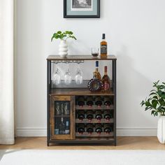 a wine rack with bottles and glasses on it in front of a wall mounted framed photograph