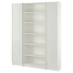 an empty white cabinet with shelves and doors