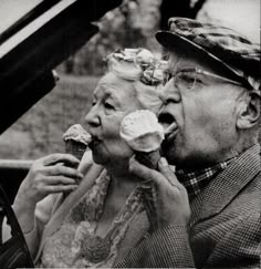 an old man and woman eating ice cream