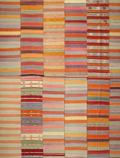 multicolored striped rugs are arranged in rows