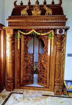 an ornate wooden door with carvings on the front and side panels, in a room