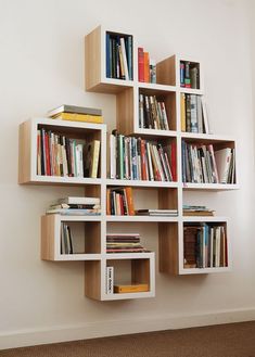 the bookshelf is made out of several square shelves