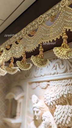 an elaborate gold beaded curtain hanging from the ceiling