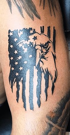 an eagle and american flag tattoo on the leg of a man's thigh,