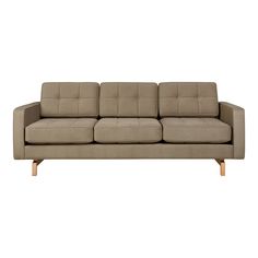 a beige couch sitting on top of a white floor