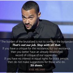 a man standing in front of a microphone with a quote on it