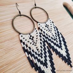 black and white beaded earrings on wooden table