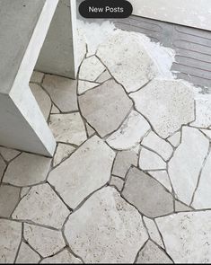 a white bench sitting on top of a stone floor