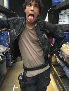 a man with his tongue out standing in a store