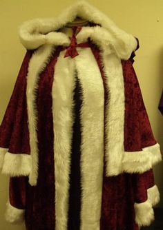 a red and white cape with fur on it