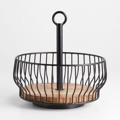 a black metal basket with a wooden cutting board in the center and an umbrella on top