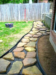 a stone path in the middle of a yard